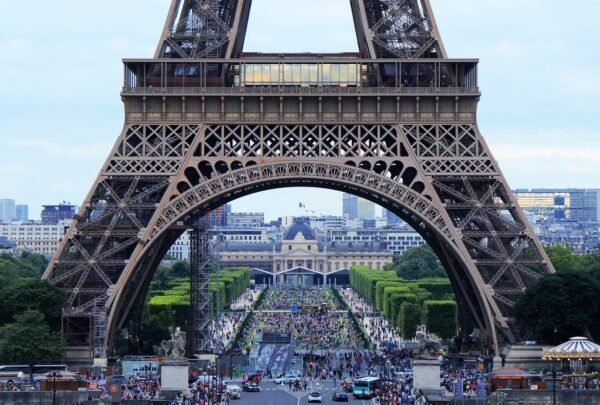 View through the Eiffel Tower arch towards the city of Paris
