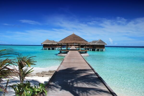 Overwater bungalows and a jetty over turquoise water in the Maldives