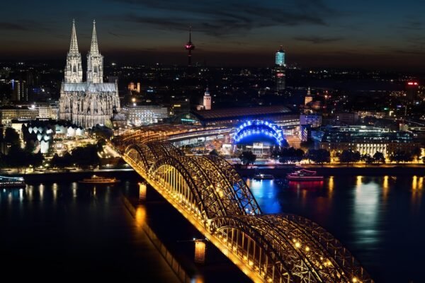 Cologne Cathedral and the Hohenzollern Bridge lit up at night
