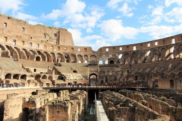 Inside the Colosseum in Rome under a blue sky