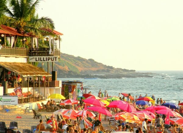 Colourful beach shacks and umbrellas on a busy Goa beach
