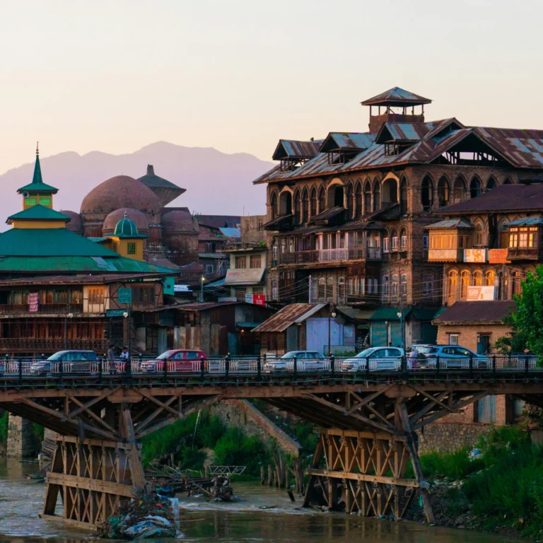 Traditional wooden houses beside a bridge in Srinagar at dusk