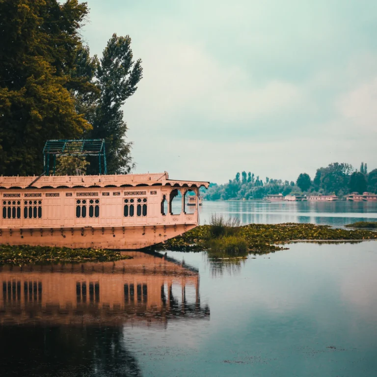 Traditional houseboat reflected in the still water of Dal Lake
