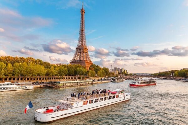 River Seine cruise boat below the Eiffel Tower in Paris