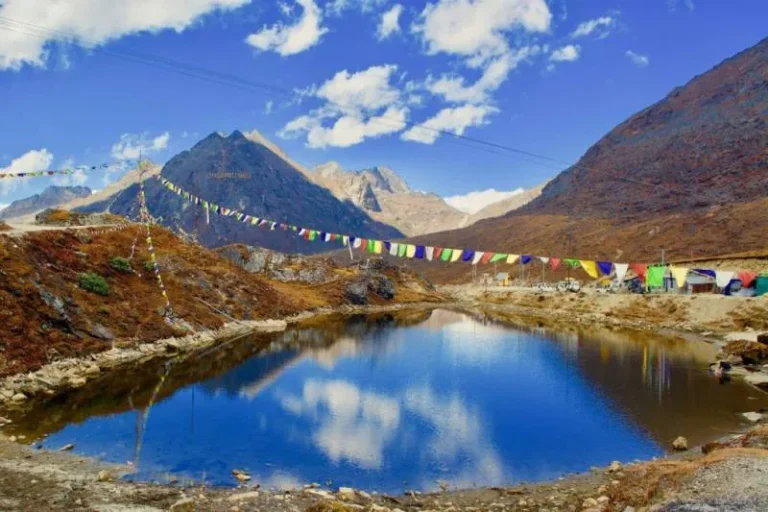 Blue Himalayan lake with prayer flags on the road to Tawang, Arunachal Pradesh