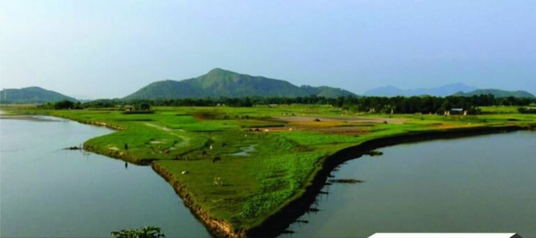 Green riverside peninsula with hills in Bongaigaon, Assam