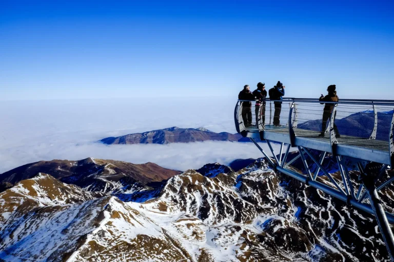 Snow-capped Himalayan peaks above the clouds seen from a mountain viewpoint in Sikkim
