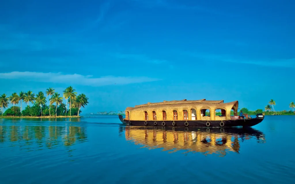 Traditional Kerala houseboat cruising calm backwaters lined with coconut palms